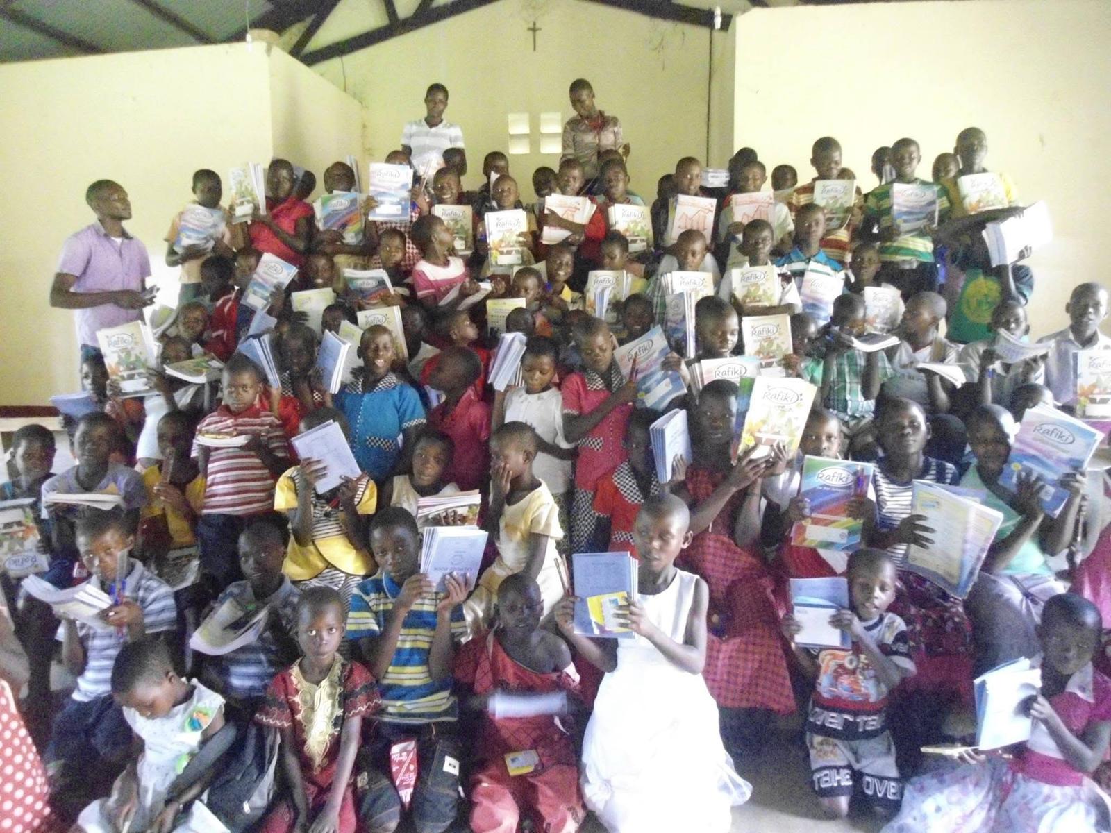 Children showing school materials